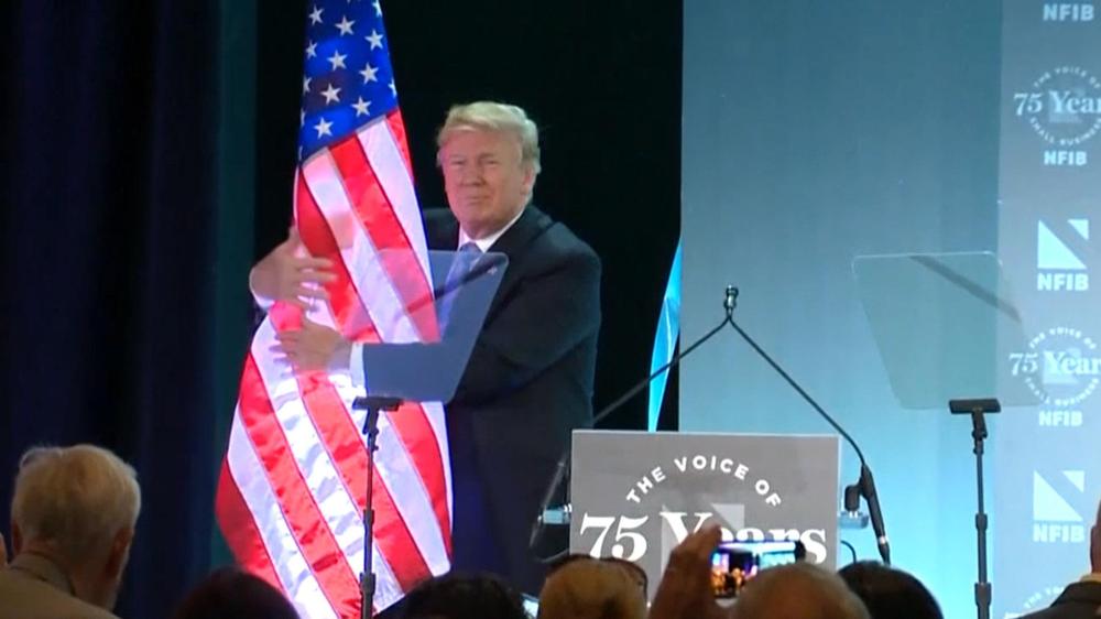 Trump caressing flag
